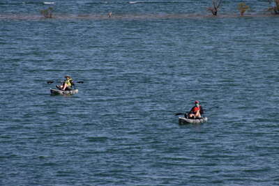 Two individuals are kayaking on Lake Blue Ridge Georgia,...