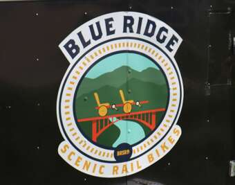 A sign for "Blue Ridge Scenic Rail Bikes" features a simple...