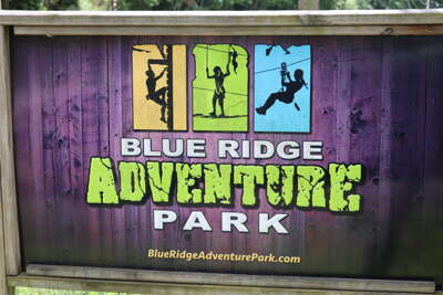 The image captures a colorful sign at Blue Ridge Adventure Park...