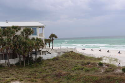 A two-story beachfront vacation rental nestled amid windswept...