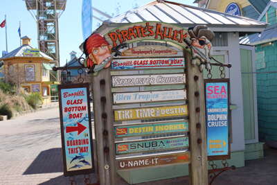 A variety of signposts featuring different ocean-related...