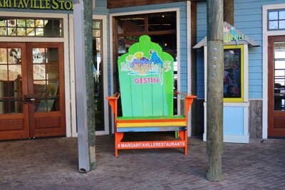 A giant, brightly colored beach chair featuring marketing for a...