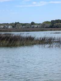 A tranquil waterway stretches across the foreground, bordered...