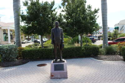 A statue of a man stands prominently in St Armands shopping...