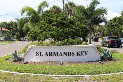 A welcoming white sign reading "St. Armands Key" is positioned...