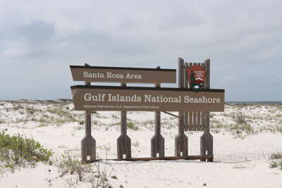 A wooden sign for the Santa Rosa Area of Gulf Islands National...