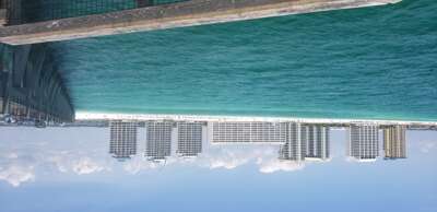 Beachfront vacation rentals line the sugary white sands of...