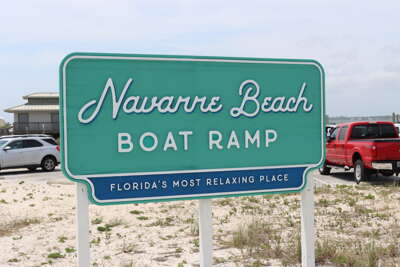 A sign for Navarre Beach Boat Ramp in Florida, described as the...