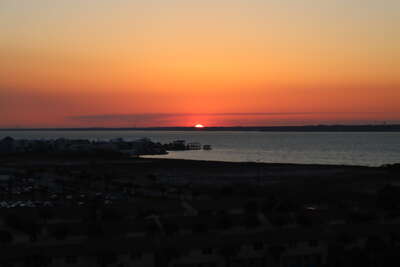 A serene sunset over Santa Rosa Sound, viewed from a beachfront...