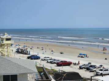 A view over New Smyrna Beach, FL scene with cars parked on the...