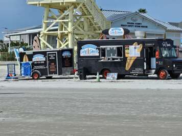 A beachfront on New Smyrna Beach, FL offers various food trucks...