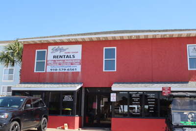 A vibrant red building on Ocean Isle Beach, NC offering beach...