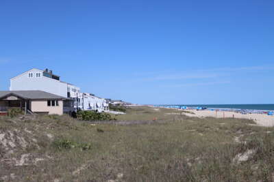 A row of vacation homes overlooks Ocean Isle Beach, NC with...