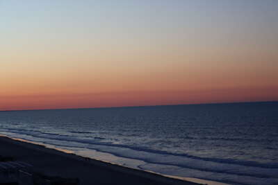 A serene view of Ocean Isle Beach, NC with gentle waves lapping...