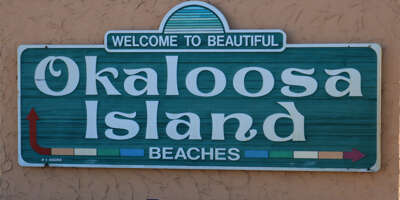 A sign directs visitors toward the beaches of Okaloosa Island...