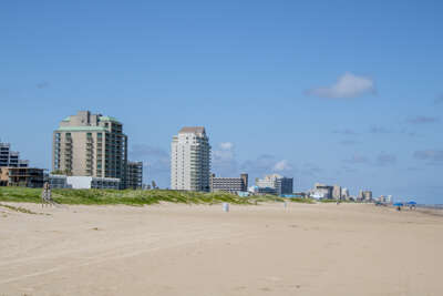 Towering buildings along the shoreline provide visitors with a...