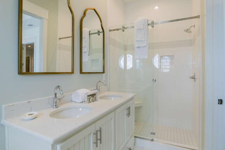 Custom tiled shower walls w/ glass sliders in every bathroom. 8 walk-in  showers &  4 tub-shower combos.