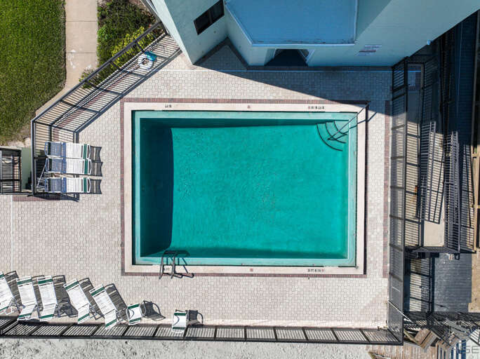 Ocean Trillium 303 (OT303) - New Smyrna Beach - Condo complex offers an oceanfront pool, an outside shower, elevator, credit card operated washer/dryer on-site, and private beach access