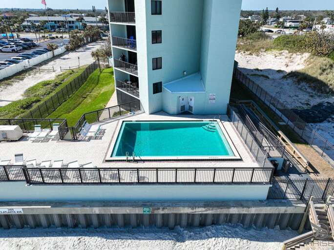 Ocean Trillium 303 (OT303) - New Smyrna Beach - Condo complex offers an oceanfront pool, an outside shower, elevator, credit card operated washer/dryer on-site, and private beach access