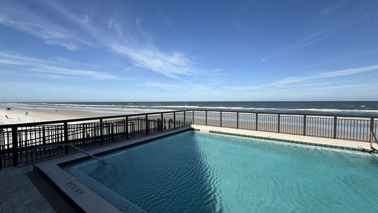 Ocean Trillium 303 (OT303) - New Smyrna Beach - Condo complex offers an oceanfront pool, an outside shower, elevator, credit card operated washer/dryer on-site, and private beach access