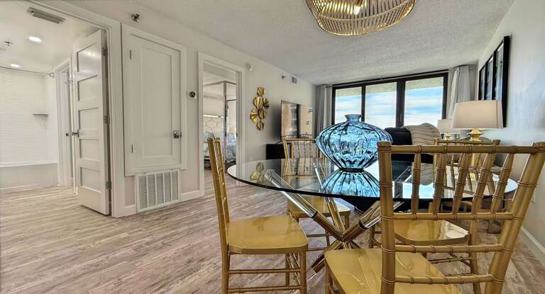Ocean Trillium 303 (OT303) - New Smyrna Beach - Eat your meals in luxury in the bright dining area which seats 4 - Expansive glass windows are a stunning backdrop as you unwind
