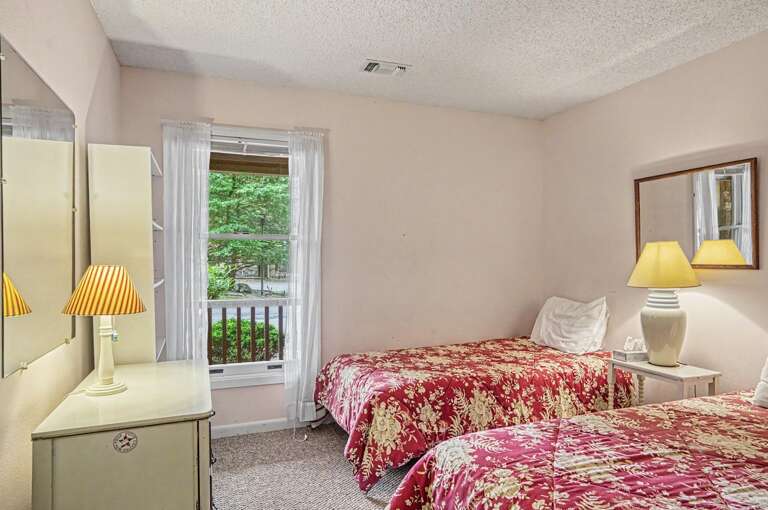 Unwind in your cozy twin bedroom, where soft natural light streams through the window and lush garden views greet you each morning.