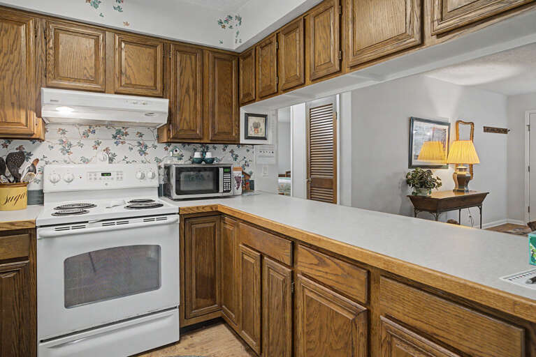 Your fully equipped kitchen features ample oak cabinetry, generous counter space, and all the appliances you need to prepare meals during your stay.
