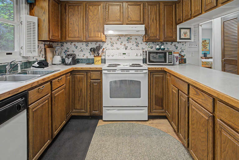 This fully-equipped kitchen features warm oak cabinetry, abundant counter space, and all the appliances you'll need to prepare your favorite meals during your stay.