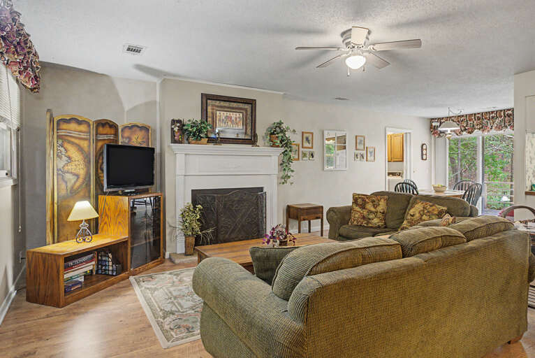 Sink into plush seating in your welcoming living room, where a cozy fireplace and soft natural light create the perfect retreat after your adventures.