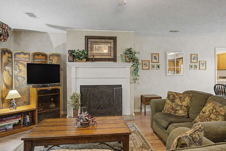 Unwind in your spacious living room, where a cozy fireplace, comfortable seating, and warm dÃ©cor create the perfect setting for relaxing evenings together.