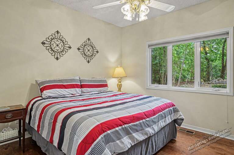 Wake refreshed in this bright bedroom where sunlight filters through the trees. Warm touches and peaceful wooded views create your perfect morning retreat.
