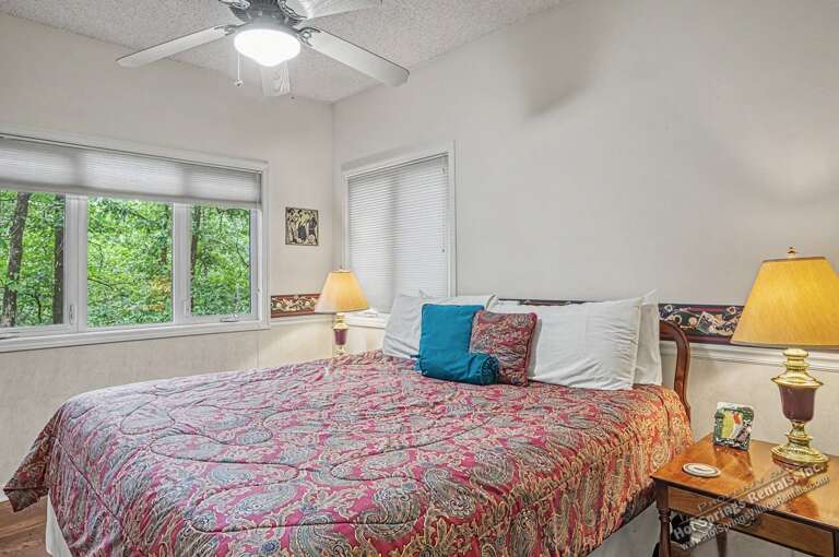 Drift off in this peaceful bedroom surrounded by lush greenery, where soft light and gentle breezes promise restful nights and refreshing mornings.