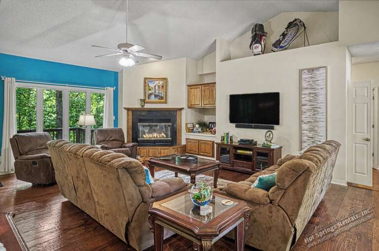 Sink into plush recliners and let the fireplace glow wash over you. Your peaceful retreat awaits, with mountain views framed beyond the glass doors and cozy evenings by the hearth.
