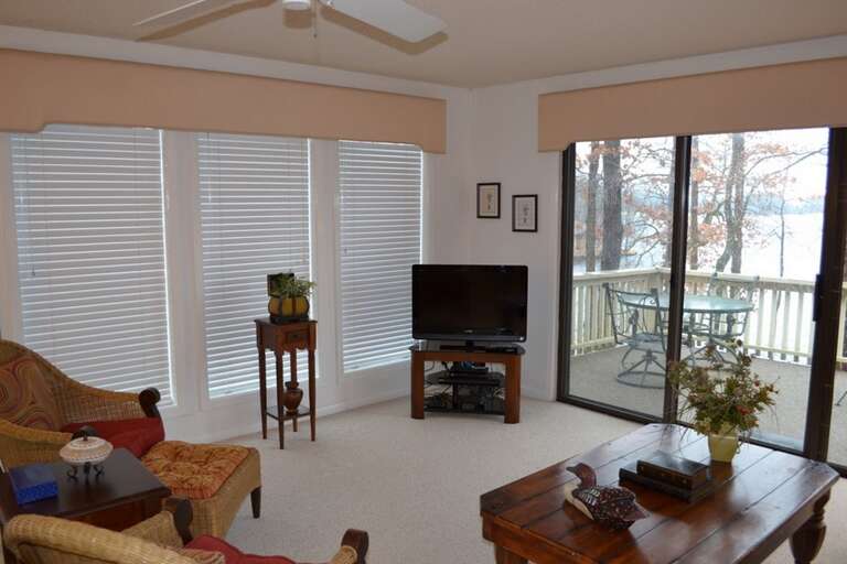 Settle into your cozy living space with serene lake views from both the main windows and your private balcony, perfect for morning coffee or evening relaxation overlooking the water.