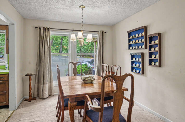 Gather around this warm dining space where sunlight streams through large windows and handcrafted shelves add a charming touchâyour meals together will feel extra special here.