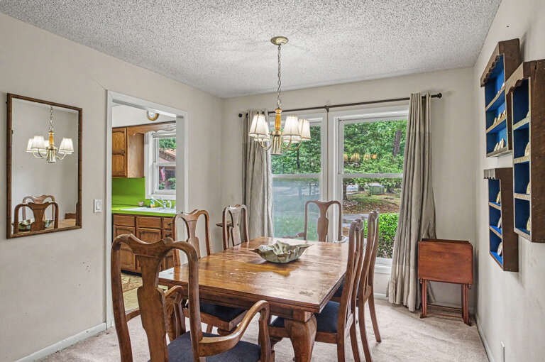 Gather around this warm wooden table for meals bathed in natural light, with garden views framing your dining experience.
