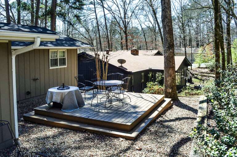 Step onto your private wooden deck where morning coffee and forest views create the perfect retreat atmosphere.
