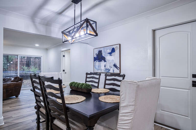 You'll love gathering around this elegant dining table, where meaningful conversations flow as naturally as the light from the stunning chandelier overhead.