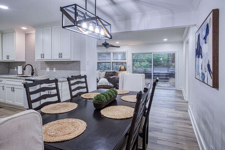 Your open-concept kitchen and dining space features elegant lighting, modern appliances, and natural light flowing through large windows.