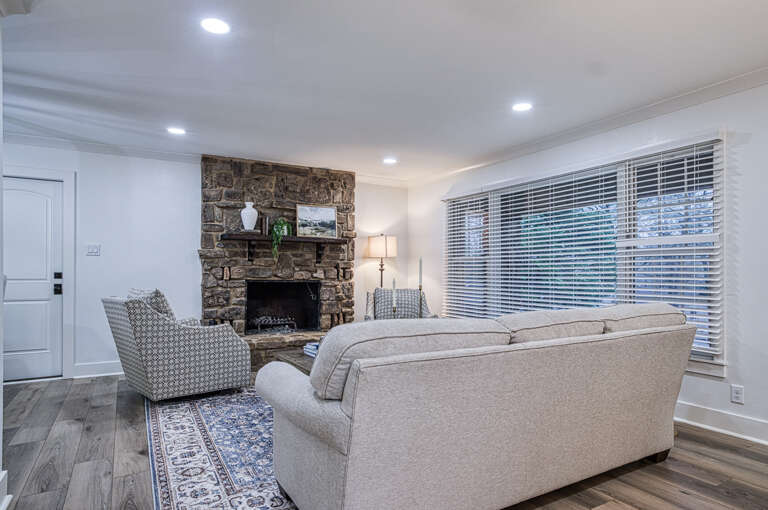 Unwind by your stone fireplace with plush seating and warm lighting creating the perfect evening retreat.