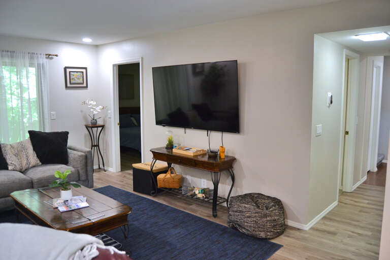 Unwind in your bright, open living room with plush seating, a large flat-screen TV, and charming dÃ©cor that invites you to kick back and truly relax.