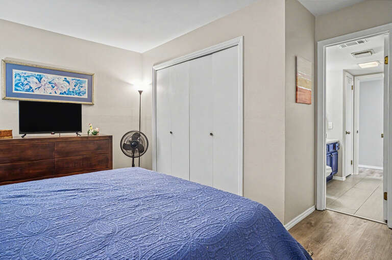 Unwind in your cozy bedroom with a plush bed, generous closet space, and a flat-screen TV for your entertainment. The soft blues and neutral tones create a calm, restful retreat.