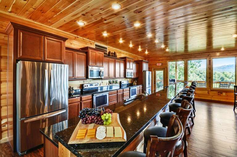 Kitchen complete with a long center island with bar seating and modern appliances.