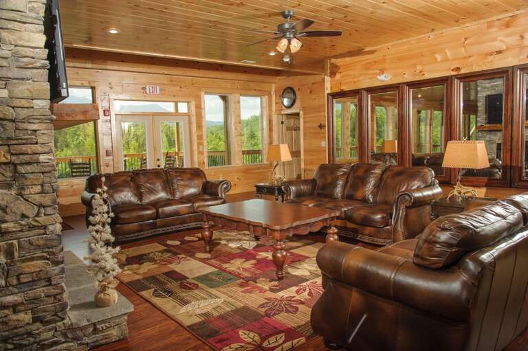 Living area with leather couches and ornate coffee table.
