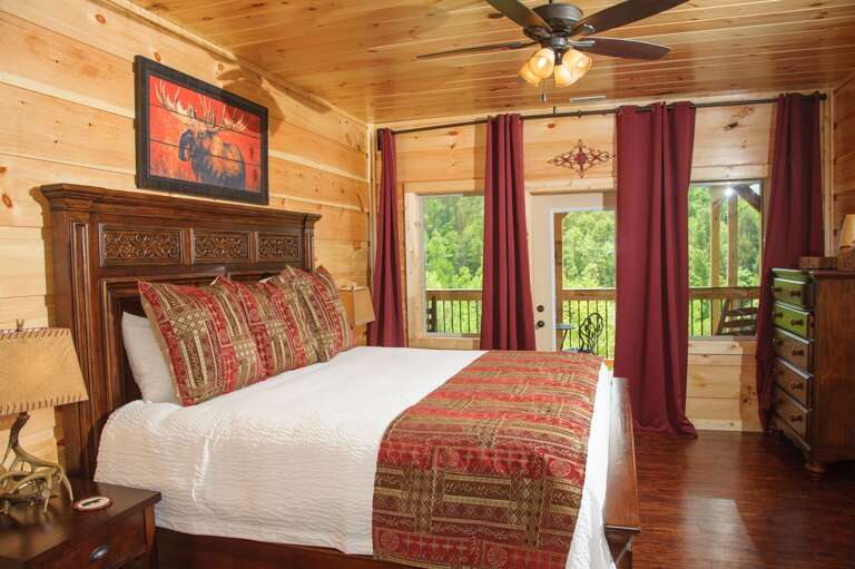 Bedroom with Large Bed, Nightstands, Lamps, and Dresser.