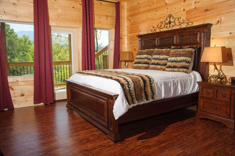Large Bed, Nightstands, Table Lamps, Curtains, and Windows.