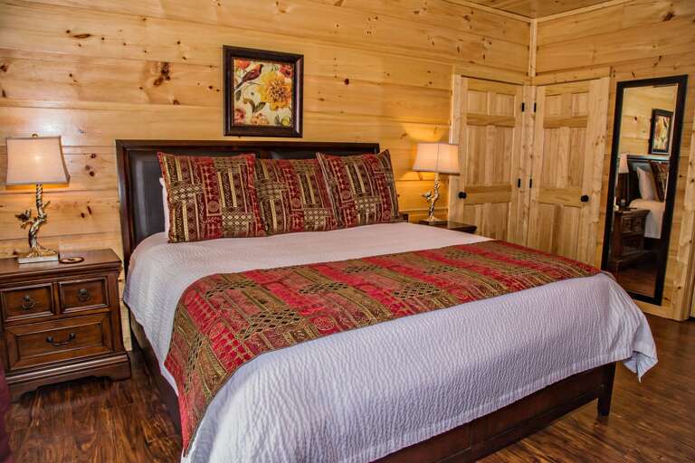 Large Bed, Nightstands, Table Lamps, and Mirror.