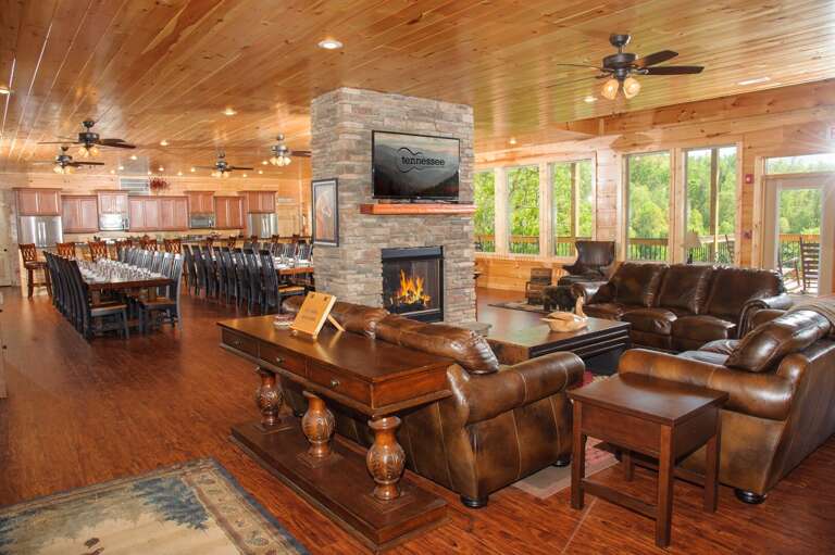 Sofas, Coffee Table, Fireplace, Table, Chairs, Two Microwaves, and Two Refrigerators.