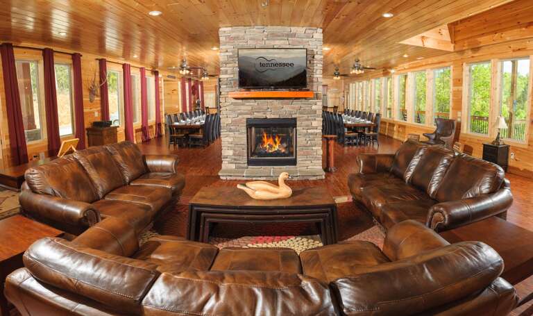 Sofas, Coffee Table, Fireplace, TV, Ceiling Fans, Tables, and Chairs.