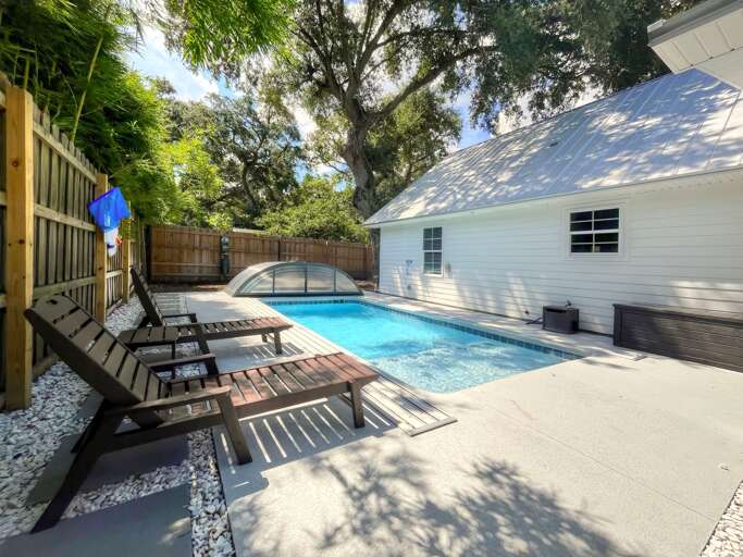 Bright Backyard, Blue Pool, Lounging Chairs Under Leafy Boughs